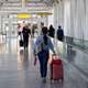 Passengers walking to the departures terminal at JFK Airport. Photo credit: Drew Angerer/Getty Images